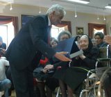 O Presidente da Junta de Freguesia de Samouco entrega a Inácia Maria de Carvalho uma placa que traduz a grande satisfação da Junta em distinguir uma senhora com 106 anos